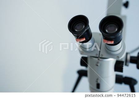 Close-up of a dental microscope on a white background 94472615