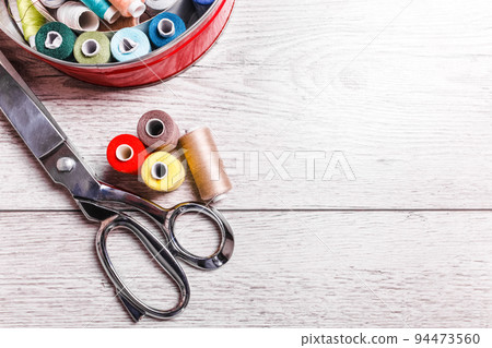 Tools for sewing. Sewing accessories on wooden background. Tools for sewing. Sewing accessories on wooden background. 94473560