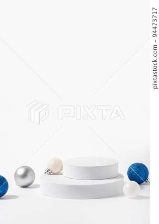 Cosmetic background for Christmas and winter holiday. White podium, christmas balls and snow on white background. Cosmetic background for Christmas and winter holiday. White podium, christmas balls and snow on white background. 94473717