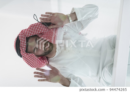 Muslim man doing sujud or sajdah on the glass floor Muslim man doing sujud or sajdah on the glass floor 94474265