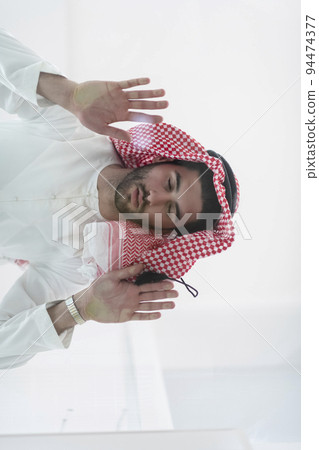 Muslim man doing sujud or sajdah on the glass floor Muslim man doing sujud or sajdah on the glass floor 94474377