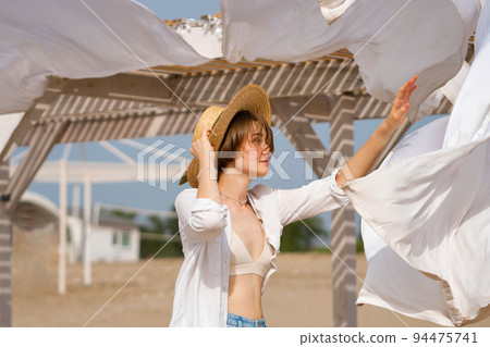 Caucasian girl on beach windy day Caucasian girl on beach windy day 94475741
