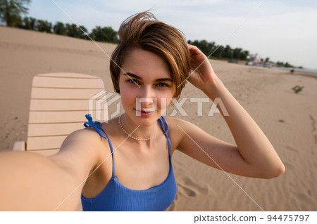 Girl making selfie on beach 94475797