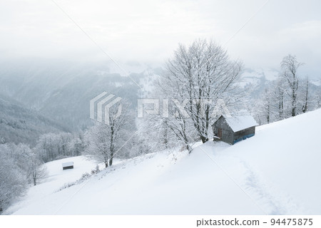 Winter landscape with a wooden cabin in the snow Winter landscape with a wooden cabin in the snow 94475875