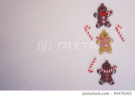 On a light background there are Christmas men, sweet canes and a place for text On a light background there are Christmas men, sweet canes and a place for text 94476561