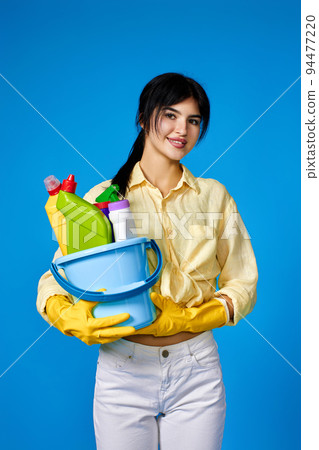 woman in gloves holding bucket with cleaning supplies woman in gloves holding bucket with cleaning supplies 94477220