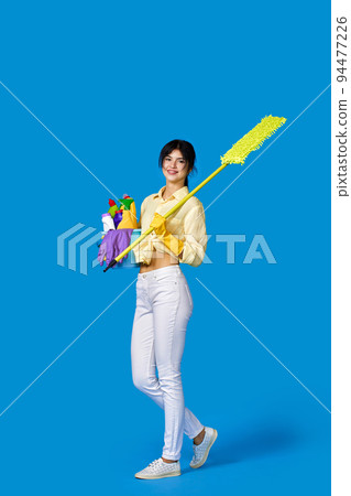 woman in rubber gloves with cleaning supplies 94477226