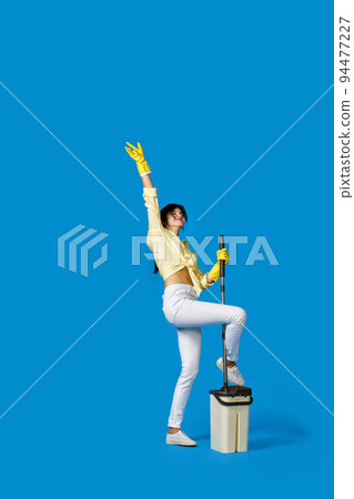 woman in rubber gloves with cleaning supplies woman in rubber gloves with cleaning supplies 94477227