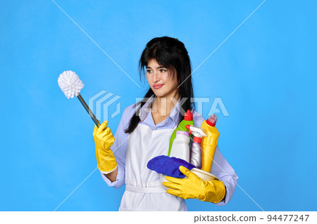 woman in gloves holding bucket of detergents 94477247