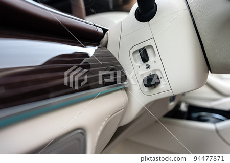 Modern luxury car interior with steering wheel, multimedia and dashboard 94477871