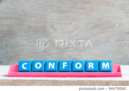 Tile alphabet letter with word conform in red color rack on wood background 94478060