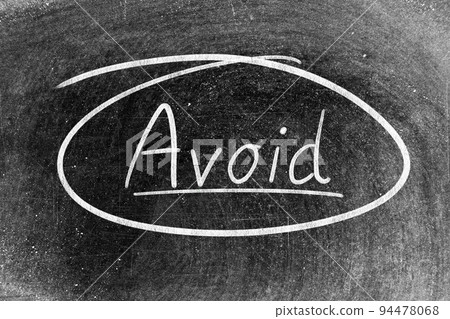 White chalk hand writing in word avoid on blackboard background 94478068
