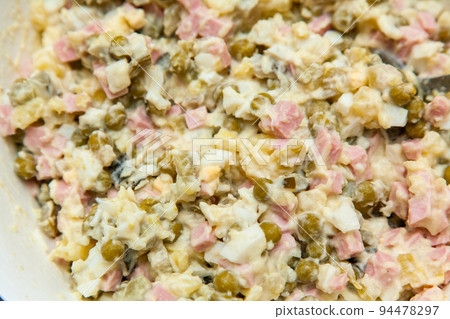 Russian salad Olivier close-up. A traditional Russian dish on the New Year's menu Russian salad Olivier close-up. A traditional Russian dish on the New Year's menu 94478297
