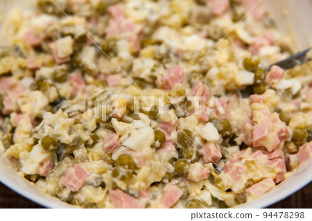 Russian salad Olivier close-up. A traditional Russian dish on the New Year's menu Russian salad Olivier close-up. A traditional Russian dish on the New Year's menu 94478298