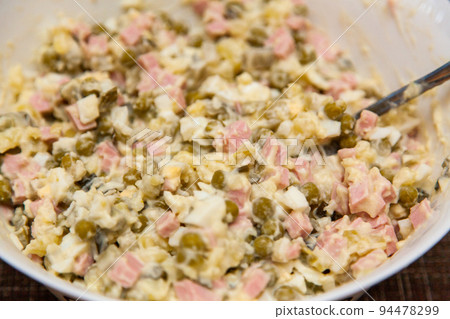 Russian salad Olivier close-up. A traditional Russian dish on the New Year's menu Russian salad Olivier close-up. A traditional Russian dish on the New Year's menu 94478299