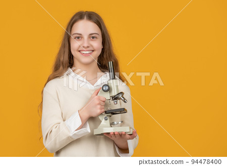 cheerful kid with microscope on yellow background cheerful kid with microscope on yellow background 94478400