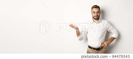Confused office worker shrugging, cant understand something, standing over white background Confused office worker shrugging, cant understand something, standing over white background 94478543