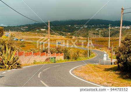 Portugal, Sintra May 2022 Winding country road near Sintra mountain with rainy clouds 94478552