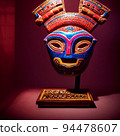 Peruvian Mayan Mask on stand in studio. Multi color. Ancient art. Studio Backdrop. Filmic lighting. Front light. Top light. Directional lighting. 94478607