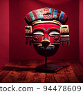 Peruvian Mayan Mask on stand in studio. Multi color. Ancient art. Studio Backdrop. Filmic lighting. Front light. Top light. Directional lighting. 94478609