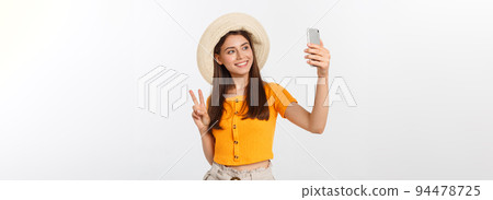 Young Caucasian woman enjoying the selfie with herself isolated on white background summer travel concept. Young Caucasian woman enjoying the selfie with herself isolated on white background summer travel concept. 94478725