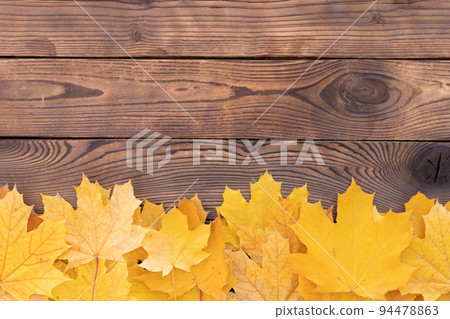 Autumn leaves frame on wooden background top view Fall Border yellow and Orange Leaves vintage wood table Copy space for text. 94478863
