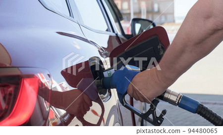 Man filling gasoline in car at gas station. Man filling gasoline in car at gas station. 94480065