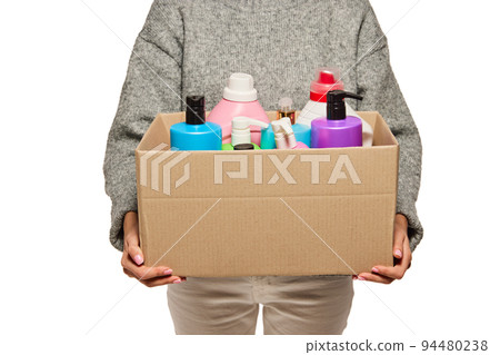 Anonymous woman holding carton box with donation, goods isolated on white background. Concept of assistant, help, support to refugees, migrants. Anonymous woman holding carton box with donation, goods isolated on white background. Concept of assistant, help, support to refugees, migrants. 94480238
