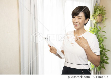 Esthetician smiling with a clipboard Esthetician smiling with a clipboard 94480993