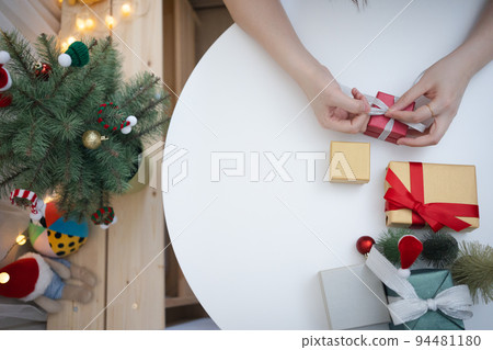 flat lay woman hand decorate christmas tree and new year  gift box 94481180