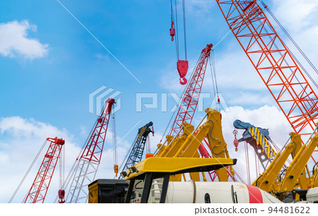 Crawler crane against blue sky. Real estate industry. Red crawler crane use reel lift up equipment in construction site. Crane for rent at parking lot. Crane dealership for construction business. 94481622