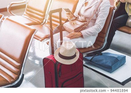 woman tourist passenger traveller using smartphone waiting for flight holiday trip tour in airport after open country woman tourist passenger traveller using smartphone waiting for flight holiday trip tour in airport after open country 94481894