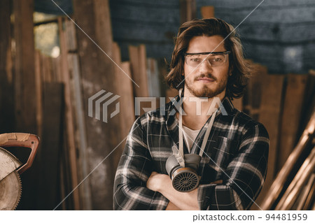 Portrait Carpenter man wood worker builder handsome smart arm crossed looking camera smiling. 94481959