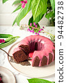 Fresh homemade chocolate bundt cake decorated with pink glaze 94482738