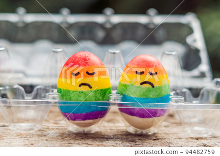 Two eggs are colored in the colors of the rainbow as a flag of gays and lesbians as well as Easter eggs. Homosexual concept Two eggs are colored in the colors of the rainbow as a flag of gays and lesbians as well as Easter eggs. Homosexual concept 94482759