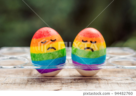 Two eggs are colored in the colors of the rainbow as a flag of gays and lesbians as well as Easter eggs. Homosexual concept Two eggs are colored in the colors of the rainbow as a flag of gays and lesbians as well as Easter eggs. Homosexual concept 94482760