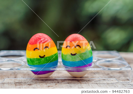 Two eggs are colored in the colors of the rainbow as a flag of gays and lesbians as well as Easter eggs. Homosexual concept 94482763
