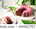 Fresh homemade chocolate bundt cake decorated with pink glaze 94482767