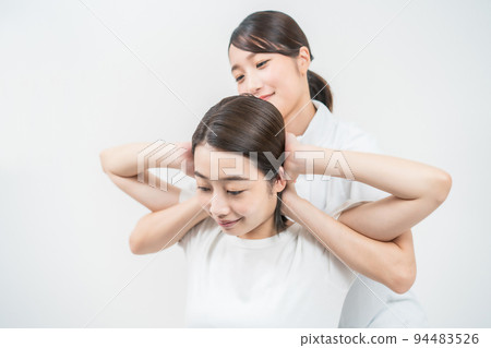 Young woman receiving a massage at an esthetic salon Young woman receiving a massage at an esthetic salon 94483526
