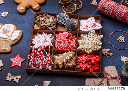 Christmas composition with gingerbread cookies, Christmas toys, pine cones and spices Christmas composition with gingerbread cookies, Christmas toys, pine cones and spices 94483679
