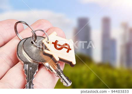 The keys to the new apartment in the hand of a man against the backdrop of urban development The keys to the new apartment in the hand of a man against the backdrop of urban development 94483833