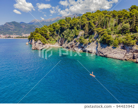 Young women Having Fun Stand Up Paddling in blue water sea in Montenegro. SUP. girl Training on Paddle Board near the rocks Portrait of a disgruntled girl sitting at a cafe table Young women Having Fun Stand Up Paddling in blue water sea in Montenegro. SUP. girl Training on Paddle Board near the rocks Portrait of a disgruntled girl sitting at a cafe table 94483942