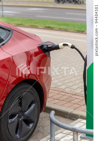 Power supply connect to electric vehicle for charge to the battery. 94484381