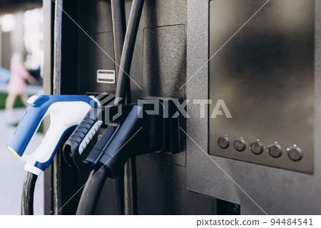Power supply for electric car charging outdoors. Socket for electrical car battery charger. Electric car charging station powered 94484541