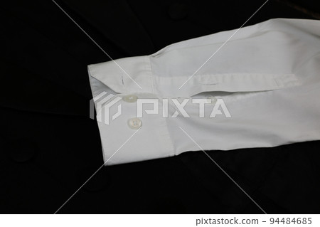 Classic tailcoat suit. White shirt, white bow tie and black jacket. Suit for ballroom dancing. Wedding accessories Classic tailcoat suit. White shirt, white bow tie and black jacket. Suit for ballroom dancing. Wedding accessories 94484685