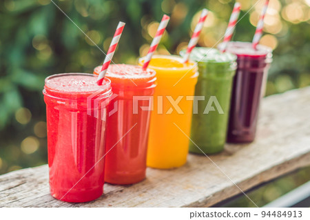Rainbow from smoothies. Watermelon, papaya, mango, spinach and dragon fruit. Smoothies, juices, beverages, drinks variety with fresh fruits on a wooden table 94484913