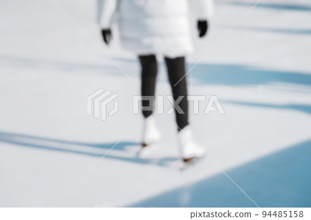 Blurred winter background, abstract girl skating on rink. Healthy winter vacation Blurred winter background, abstract girl skating on rink. Healthy winter vacation 94485158