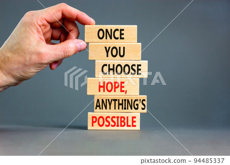 Hope and anything is possible symbol. Concept words Once you choose hope anything is possible on wooden blocks on a beautiful grey background. Businessman hand. Business and hope concept. Copy space. Hope and anything is possible symbol. Concept words Once you choose hope anything is possible on wooden blocks on a beautiful grey background. Businessman hand. Business and hope concept. Copy space. 94485337
