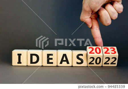2023 ideas new year symbol. Businessman turns a wooden cube and changes words Ideas 2022 to Ideas 2023. Beautiful grey table grey background, copy space. Business 2023 ideas new year concept. 2023 ideas new year symbol. Businessman turns a wooden cube and changes words Ideas 2022 to Ideas 2023. Beautiful grey table grey background, copy space. Business 2023 ideas new year concept. 94485339