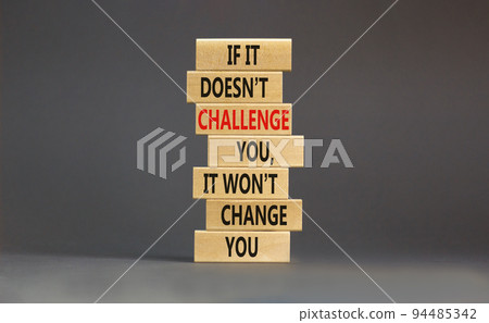 Challenge to change symbol. Concept words If it does not challenge you it wont change you on blocks on a beautiful grey table grey background. Business motivational and challenge concept. Challenge to change symbol. Concept words If it does not challenge you it wont change you on blocks on a beautiful grey table grey background. Business motivational and challenge concept. 94485342
